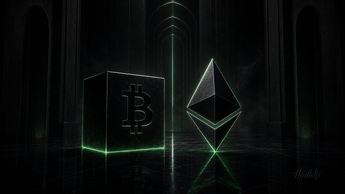 The Bitcoin cube and the Ethereum diamond standing side by side, edged in green light